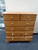 A contemporary pine effect chest of six drawers