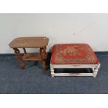An Indian heavily carved occasional table and an upholsterd footstool