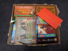 A box containing a large quantity of 20th century board games, Snakes and Ladders, War of Masters,