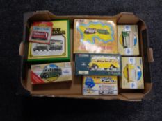 A box containing boxed Corgi die cast trams and buses.