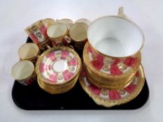 A tray containing approximately 37 pieces of 20th century pink and gilt tea china.