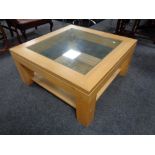 An oak effect and glass top square coffee table