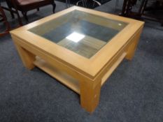 An oak effect and glass top square coffee table