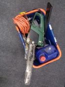 A box containing Black and Decker electric chain saw, extension lead etc.
