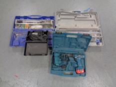 A boxed Makita drill with charger, boxed rotazip,