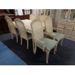 A contemporary extending dining table with leaf together with a set of six bergere backed dining