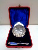 A cased silver shell-form dish together with a silver knife