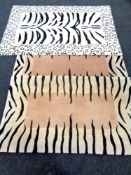 Three contemporary zebra pattern rugs.