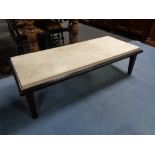 A contemporary rectangular coffee table with inset marble top
