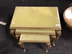 A nest of three gilt brass and onyx tables