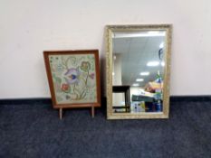 A contemporary gilt framed bevel edged over mantel mirror together with an embroidered fire screen.