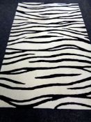 Three contemporary zebra patterned rugs.