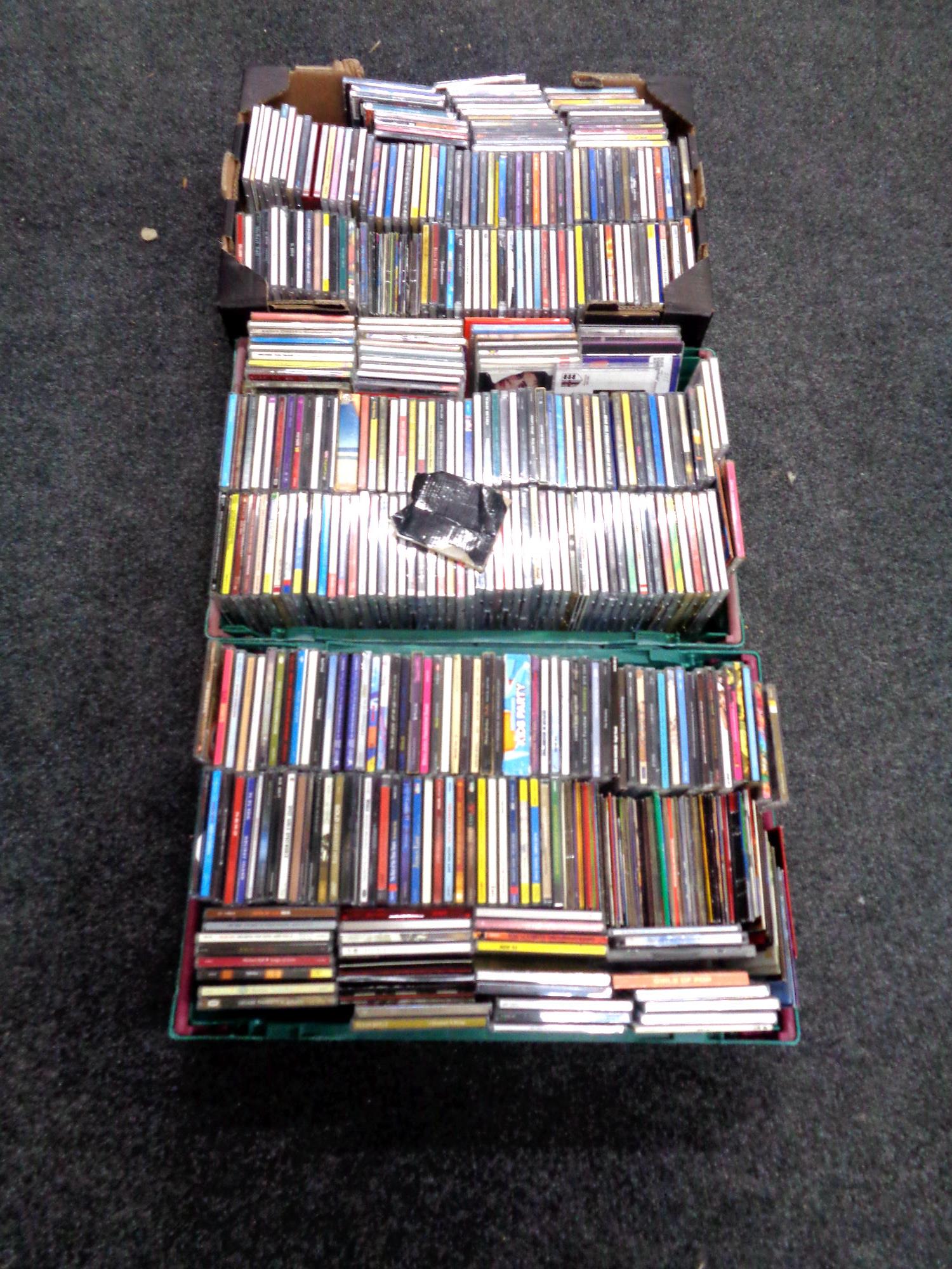 Three boxes containing a quantity of CDs.