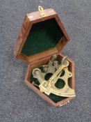 A reproduction brass sextant in teak box