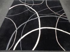 A contemporary machined carpet on black ground,