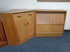 An oak sliding door cabinet and matching corner cabinet
