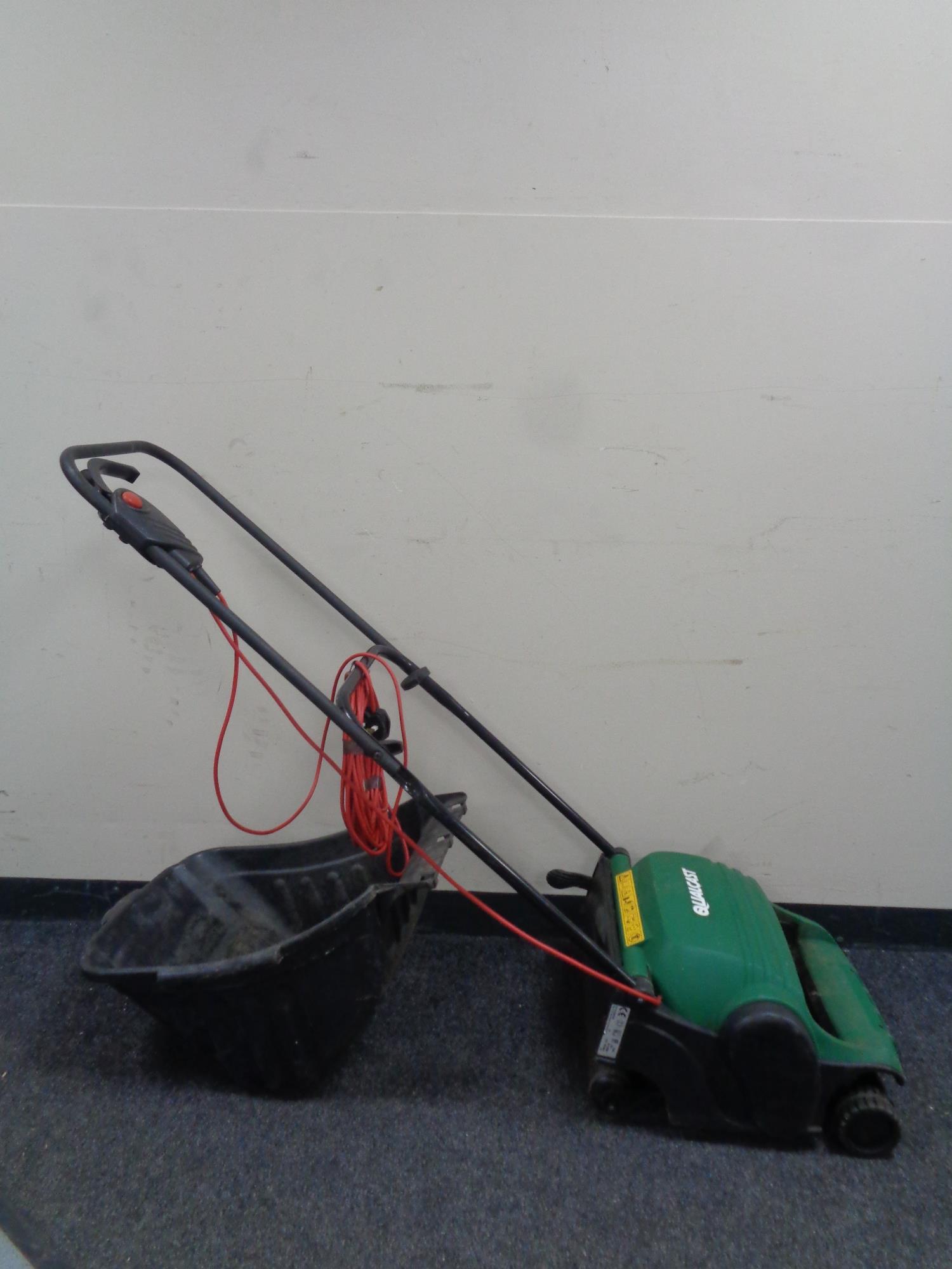 A Qualcast electric lawn raker