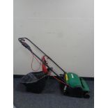 A Qualcast electric lawn raker