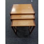 A nest of three teak tables