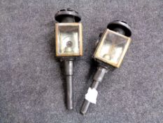 A pair of painted metal coach lamps.