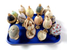 A tray containing a quantity of decorative egg ornaments on stands,