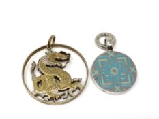 A sterling silver and enamel pendant together with a fine silver gilt pendant.