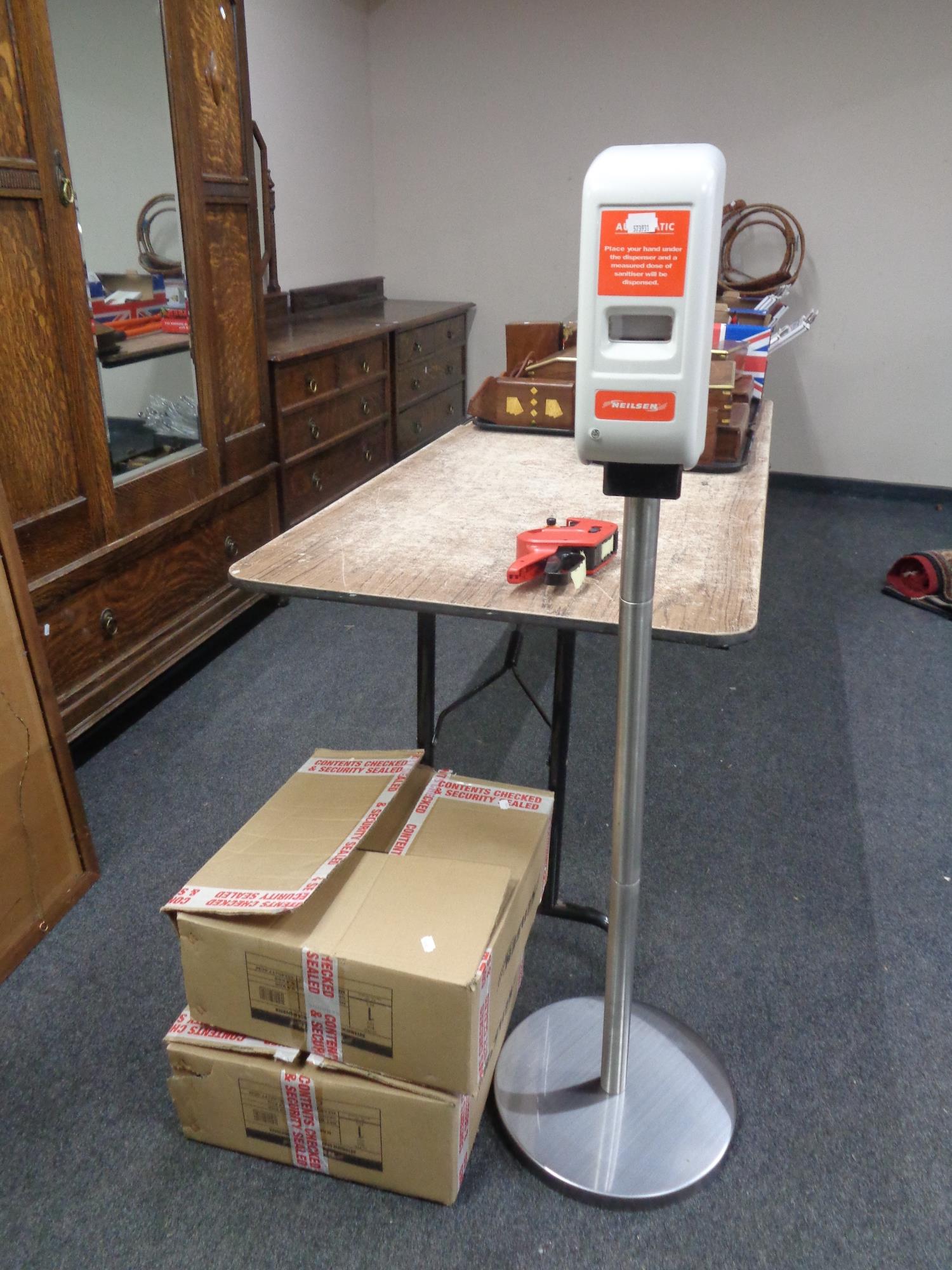 A Neilsen automatic hand sanitizer dispenser and one further dispenser in box