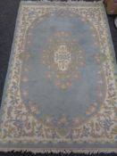 A fringed Chinese rug on blue ground 190 x 122 cm