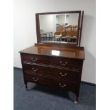 A late Victorian four drawer dressing table raised on shepherd's castors