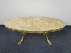 A gilt brass and onyx topped oval coffee table