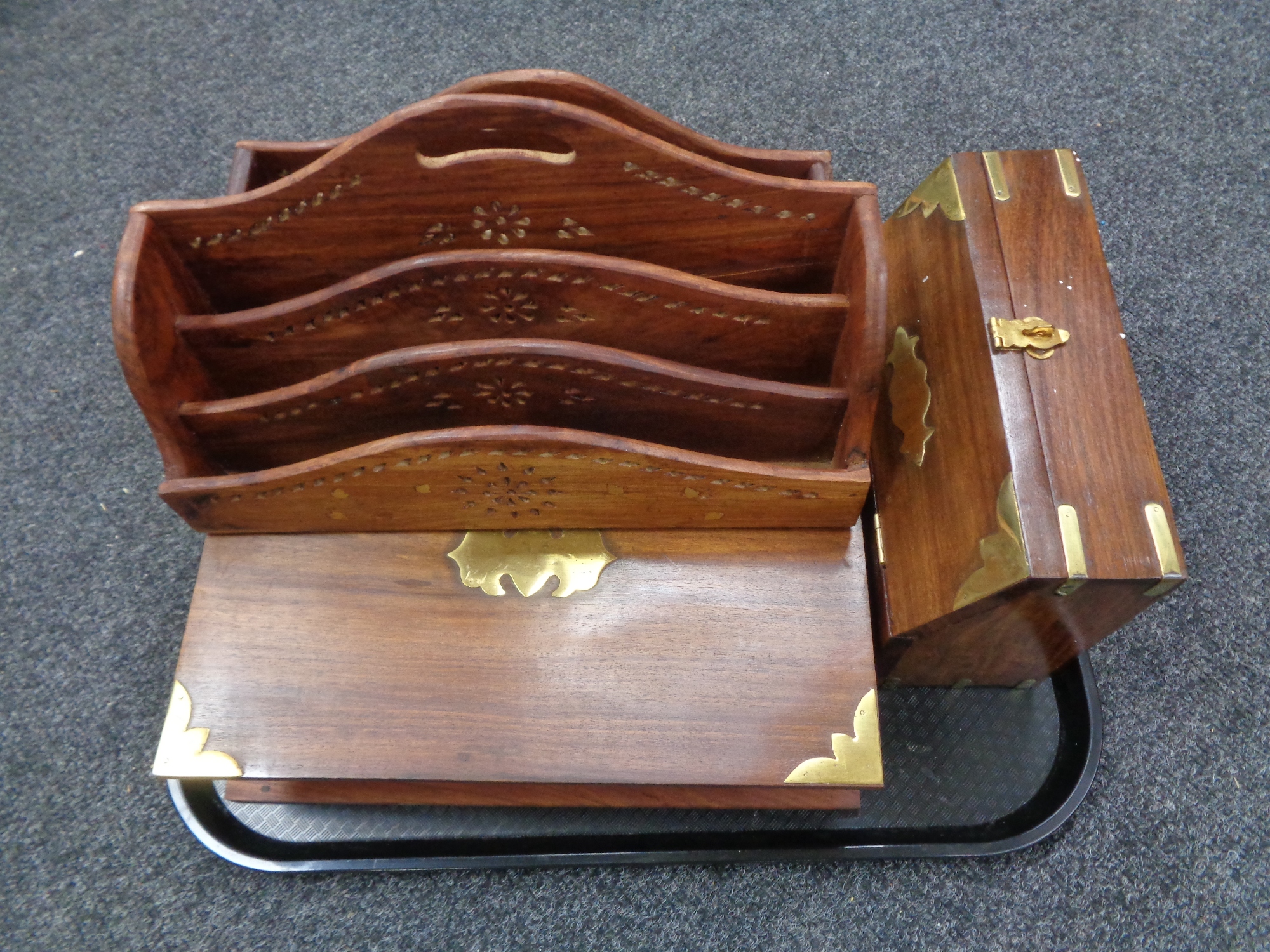 A tray containing two hardwood brass inlaid letter racks together with a brass mounted hardwood