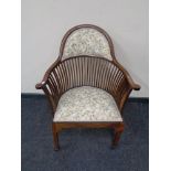 A beech spindle back armchair in tapestry fabric