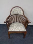 A beech spindle back armchair in tapestry fabric
