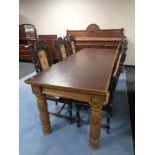 A heavily carved oak Elizabethan style refectory dining table with brown faux leather inset