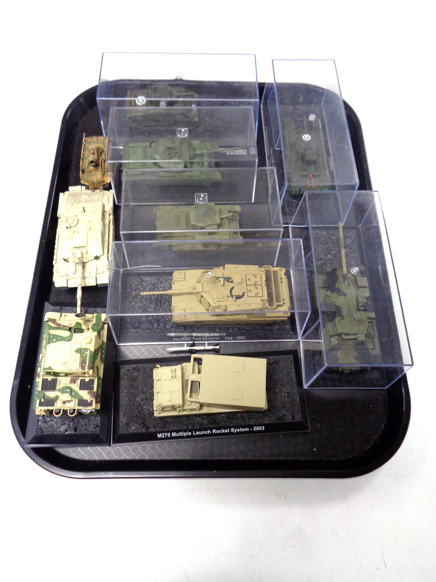 A tray containing ten various die cast tanks and other military vehicles.