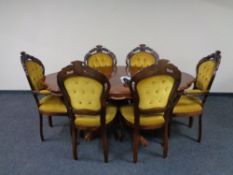 An Italianate inlaid shaped dining table together with a set of six carved dining chairs in