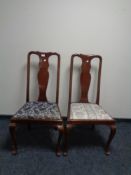 A pair of mahogany Queen Anne style dining chairs together with a circular fringed Indian rug.