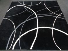 A contemporary machined carpet on black ground,