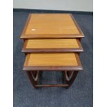 A nest of three teak tables