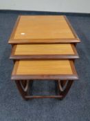 A nest of three teak tables