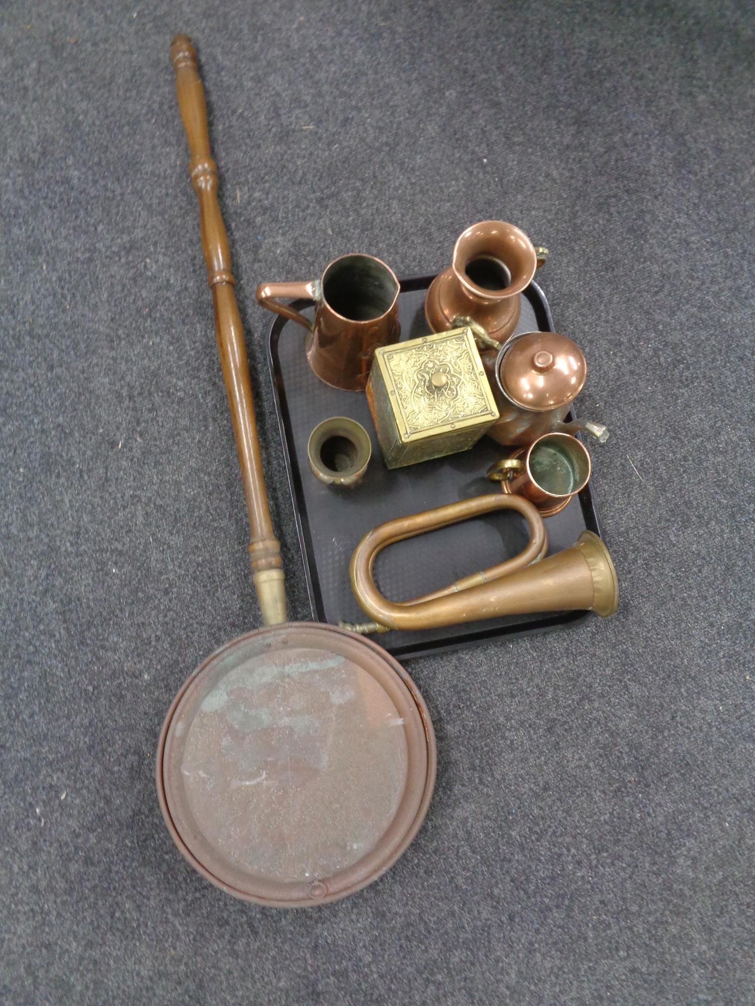 A copper bed warming pan together with tray of metal wares including copper bugle,