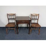 A 19th century oak single drawer side table and a pair of elm wood dining chairs