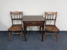 A 19th century oak single drawer side table and a pair of elm wood dining chairs