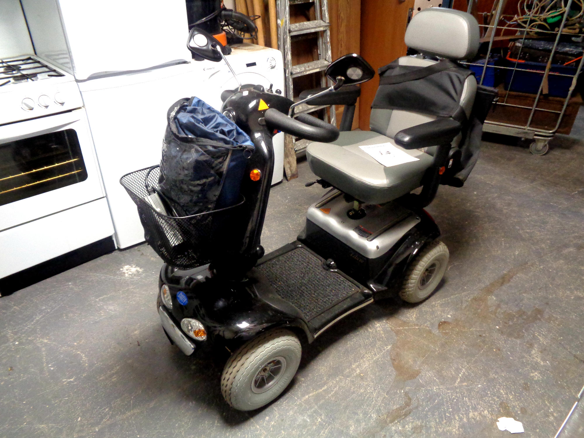 A Shoprider Cadiz Model S-889SL mobility cart with charger,