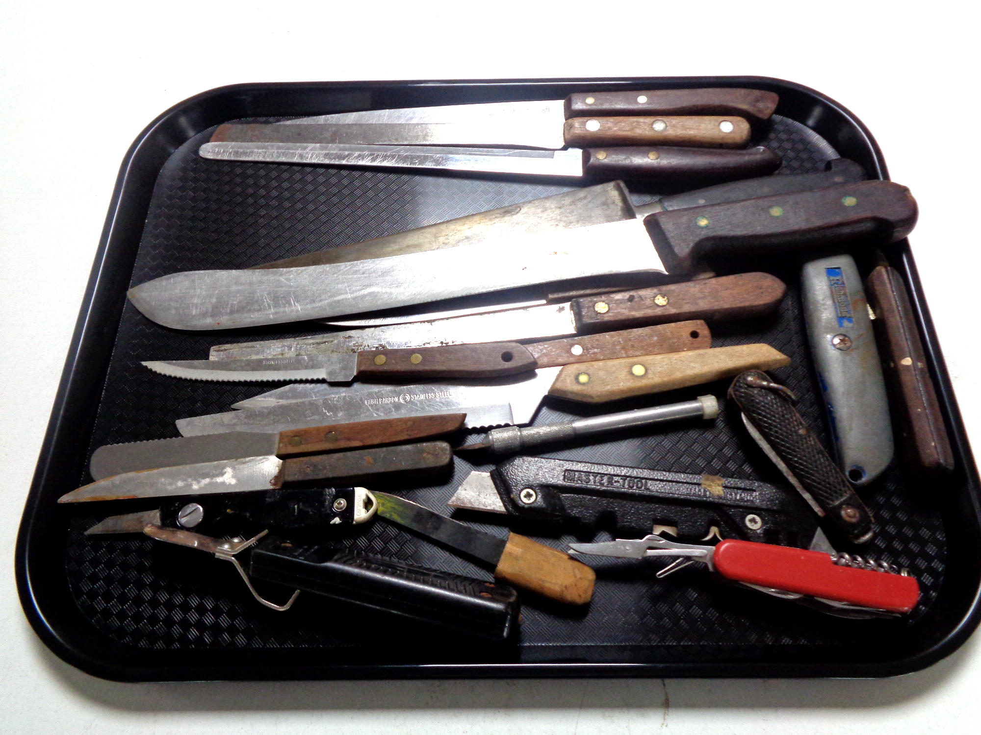 A tray containing a collection of knives to include kitchen knives, steak knives,