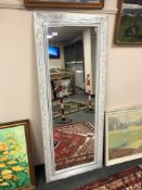A contemporary white framed mirror 64 x 158 cm