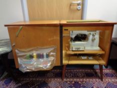 A 20th century Husqvarna 2000 electric sewing machine in teak cabinet with sewing accessories