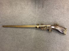 An ornamental brass and wood musket
