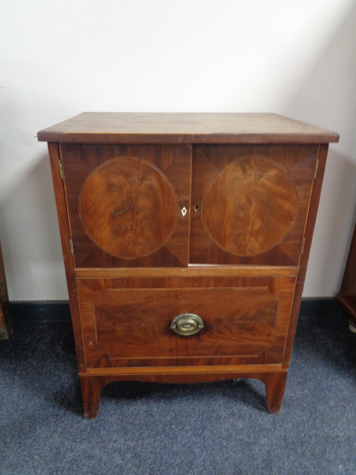 A 19th century inlaid mahogany double door cabinet fitted a drawer beneath