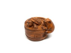 A carved hardwood Chinese netsuke - Frog and Turtle in barrel